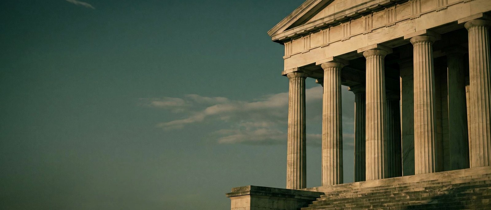 Stone facade of a state capitol at dusk